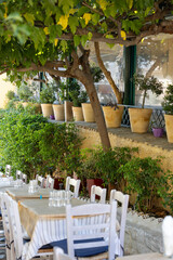 Outdoor restaurant on the stairs on the way to the Acropolis in the Plaka district, old historical neighborhood of Athens, Greece
