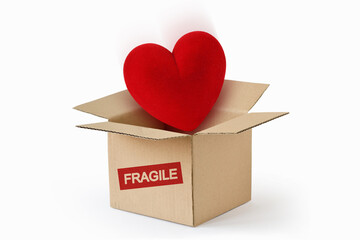 Heart in cardboard box with the Word Fragile - Concept of love and fragility