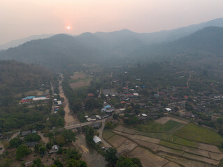 High-angle landscape Toxic dust covered the village surrounded by mountains. In the evening when...