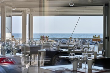 Beachfront restaurant with a panoramic view of the ocean and its sandy shoreline