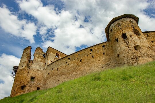 Low angle of the majestic Zborov Castle perched atop a rolling hill in Eastern Slovakia