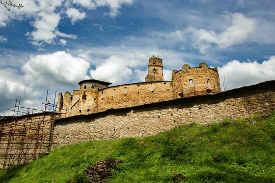 Low angle of the majestic Zborov Castle perched atop a rolling hill in Eastern Slovakia