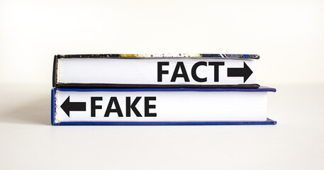 Fact or fake symbol. Concept word Fake and Fact on beautiful books. Beautiful white table white background. Business and fact or fake concept. Copy space.