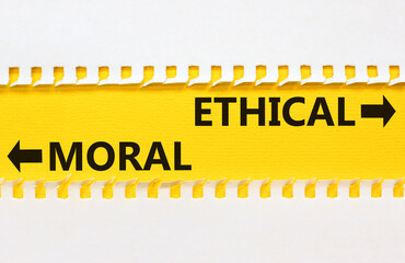 Ethical or moral symbol. Concept word Ethical or Moral on beautiful yellow paper. Beautiful white...