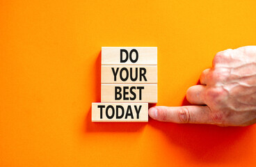 Do your best today symbol. Concept words Do your best today on beautiful wooden block. Beautiful orange table background. Businessman hand. Business motivational do your best today concept. Copy space