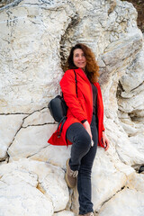 Portrait of beautiful young woman wearing red jacket outdoors - 768827851