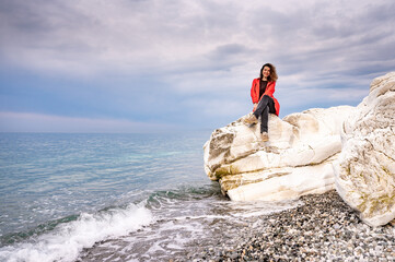 girl in a red jacket on the seashore - 768827869