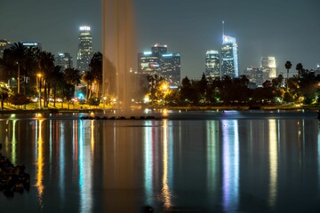 Fototapeta na wymiar City of Los Angeles illuminated by the night sky with a majestic fountain in the foreground