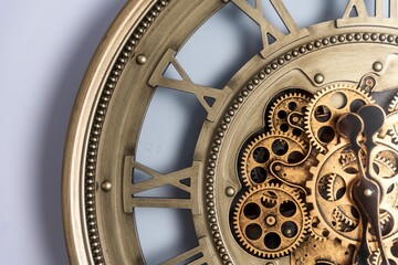 Closeup of an antique-style wooden clock on a white wall