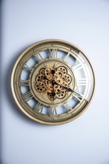 Closeup of an antique-style wooden clock on a white wall