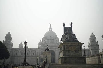 Statue of Queen Victoria in front of the Victoria Memorial architectural building in Kolkata, India.