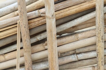 Large collection of wooden sticks of various sizes, arranged in a neat stack