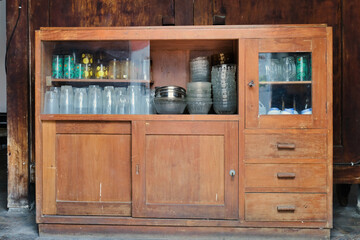 A wooden cupboard used to store glassware
