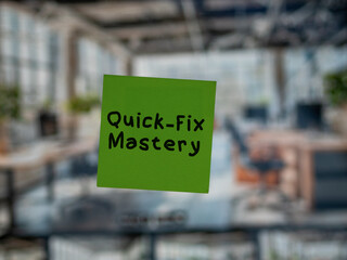 Post note on glass with 'Quick-Fix Mastery'.