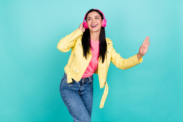 Photo of youngster girl enjoy favorite playlist headphones look empty space isolated over teal...