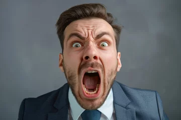 Fotobehang Man Shouting. Furious angry young businessman shouting and yelling © Igor