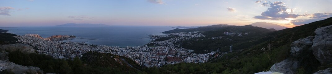 Fototapeta na wymiar Stunning view of the sea and the coastal city of Kavala, Greece at sunset