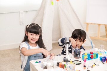 young boy and girl learning test science at home school