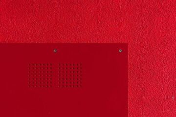 Minimalistic interior featuring a single red-painted square with white polka-dot accents