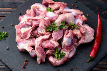 Fototapety  Raw chicken giblets gizzard ( stomach ) , meat background