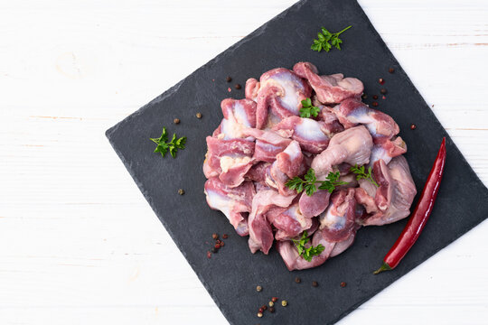 Raw chicken giblets gizzard ( stomach ) , meat background