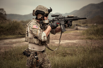 Soldiers  in camouflage uniforms aiming with their rifles.ready to fire during Military Operation...