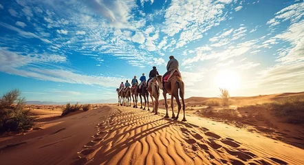 Foto op Plexiglas The group of people riding camels in the desert dunes, backlighting © K'kriang Krai
