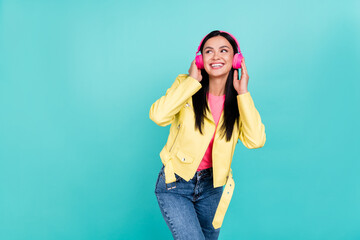 Photo of young youth cheerful lady wondered look empty space listen radio earphones isolated over...