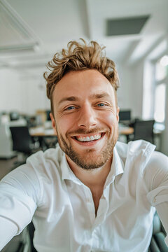 smiling selfie at the office happy young man camera portrait work life
