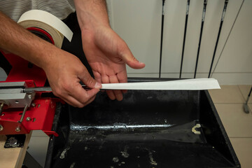 Golfer Changing Golf Grip On Golf Club in Switzerland.