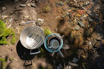 unwashed dishes on the beach of river