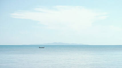 A small boat of fisherman floats in the the sea.