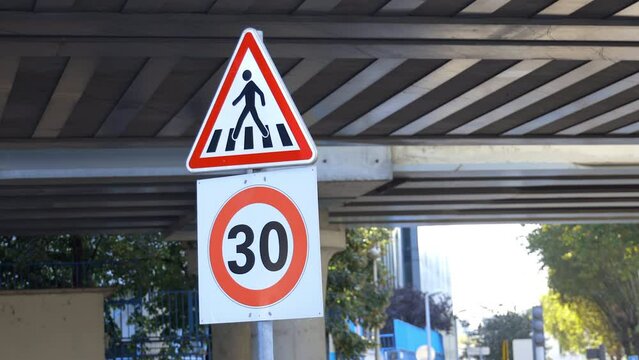 30 road sign, indicating the limit zone of thirty kilometers per hour for cars and pedestrian crossing triangle sign