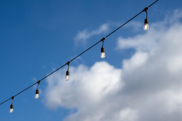 Party lights in front of a blue sky
