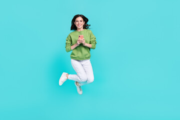 Full body portrait of pretty excited person hold telephone enjoy free time isolated on teal color background - 768860239