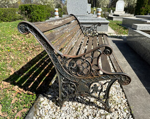 Old ornate metal bench in the public cemetery - Powered by Adobe