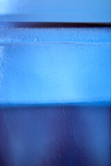 A close-up view of a blue glass object, highlighting the textured surface that creates a visually...