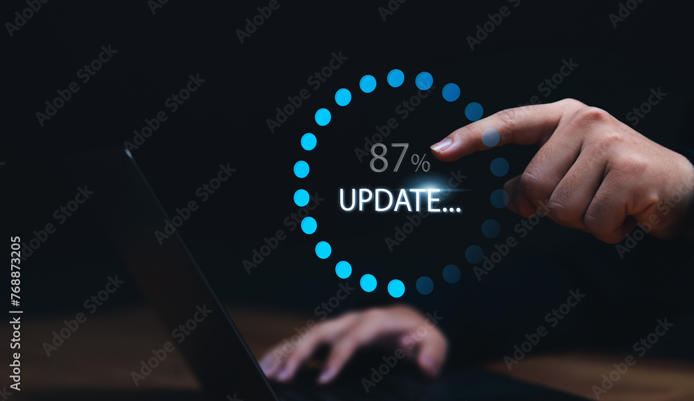 Fototapete Businessman updating computer system for device operating system to be up to date with new version. Graphics icon showing updating function screen loading on computer laptop.