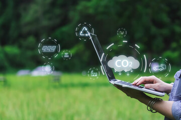 Reducing CO2 emissions and combat global warming and climate change. In nature using tablet planning new ideas and technology for eco-friendly solutions for a sustainable future.