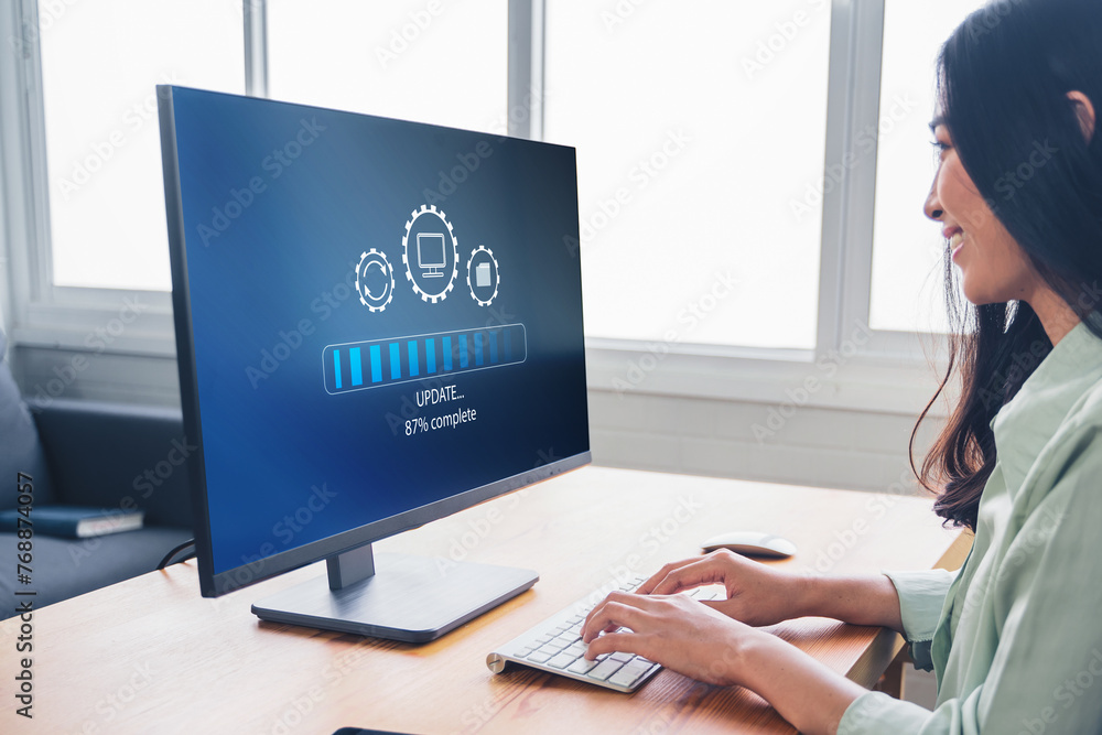 Poster working in office desktop installing update system software for device operating systems to be up to