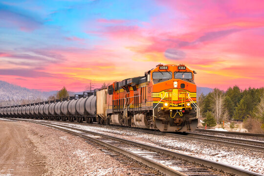 freight train in early with beautiful sunset in background close to Whitefish, Montanaq