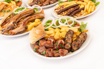 Cypriot Seftalia and Pork Chopped meal with fries and salad