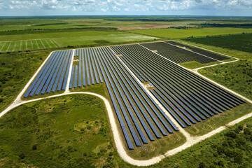 Aerial view of big sustainable electric power plant with many rows of solar photovoltaic panels for...