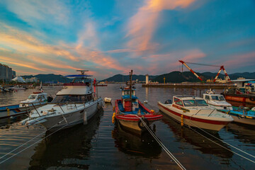 The sunset view of Masan Port in Changwon, South Gyeongsang Province, South Korea, where meat boats are anchored at the mooring.