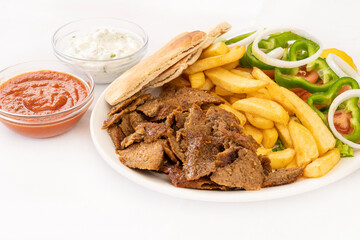 Greek gyros meat meal with french fries and salad