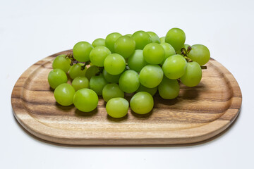 Shine Muscat grapes on a white background.