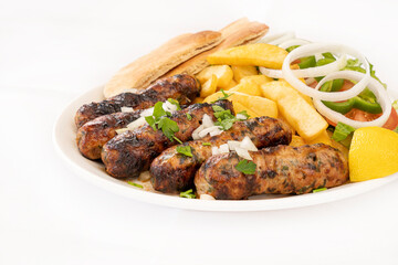 Cypriot Seftalia meal with fries and salad