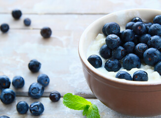breakfast porridge with fresh blueberries in a bowl