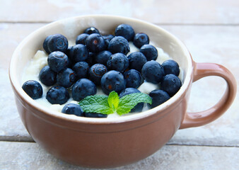 breakfast porridge with fresh blueberries in a bowl
