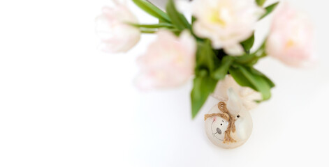 bouquet of tulips and Easter bunny on white table. copy space